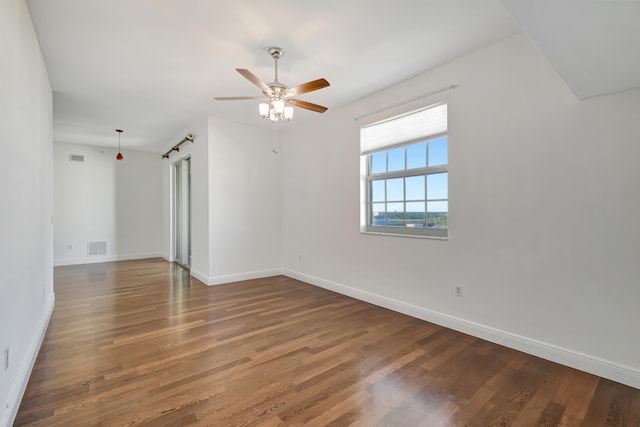 unfurnished room featuring ceiling fan and dark hardwood / wood-style flooring