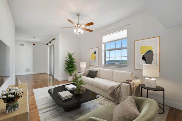 living room with hardwood / wood-style flooring and ceiling fan