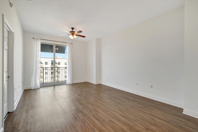 empty room featuring ceiling fan and dark wood-type flooring