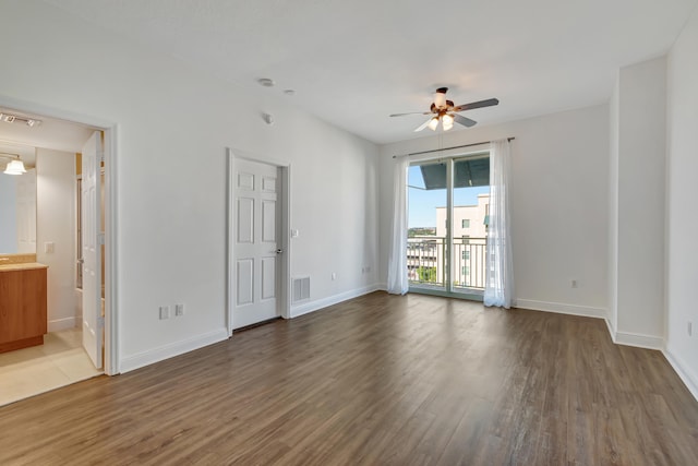 empty room featuring ceiling fan and dark wood-type flooring