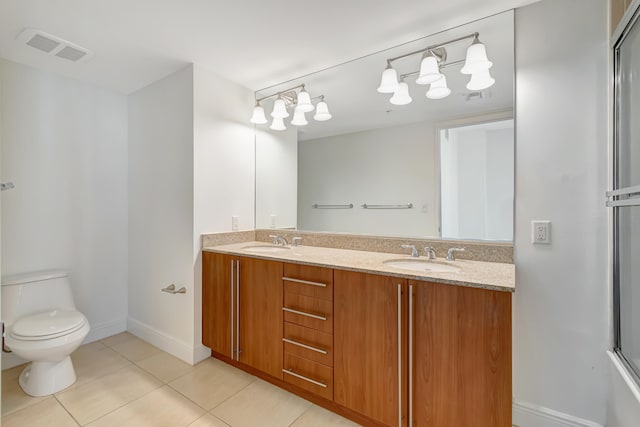 bathroom with tile patterned flooring, vanity, toilet, and a shower with shower door