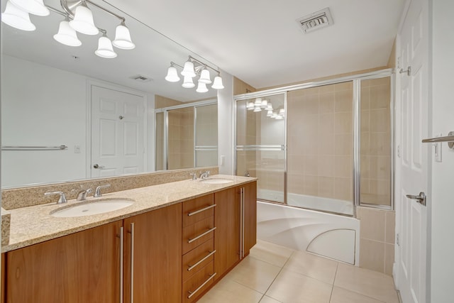 bathroom with tile patterned floors, vanity, and enclosed tub / shower combo