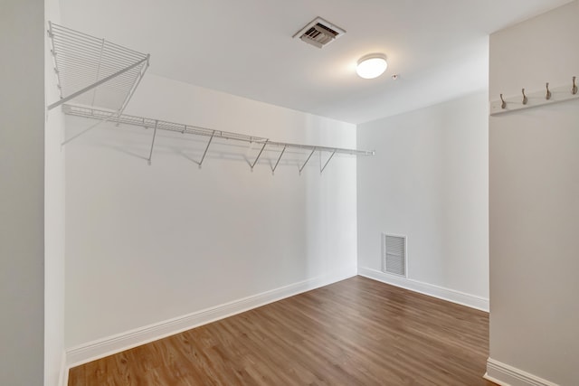 spacious closet featuring dark hardwood / wood-style flooring