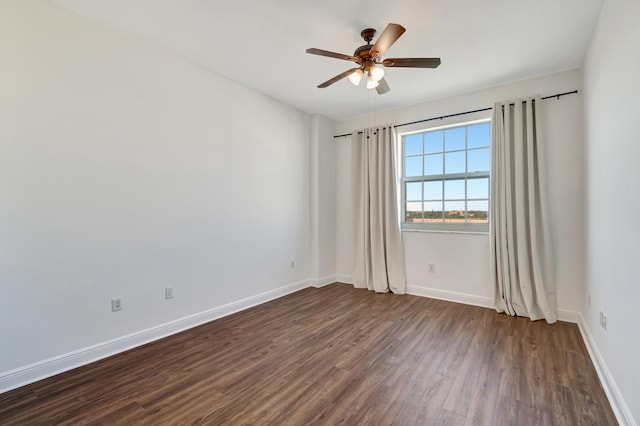 empty room with dark hardwood / wood-style floors and ceiling fan