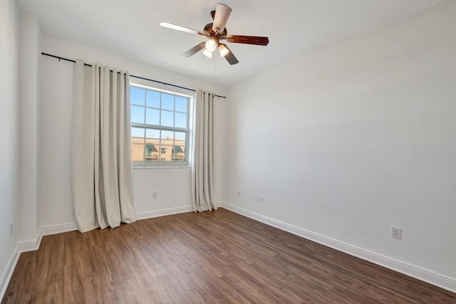 spare room with ceiling fan and dark hardwood / wood-style flooring