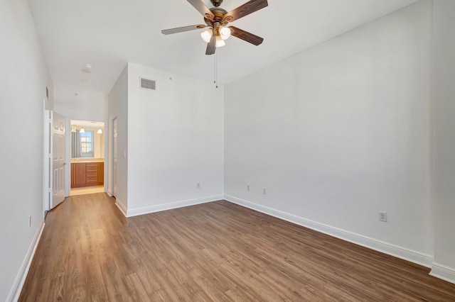 spare room featuring hardwood / wood-style floors and ceiling fan