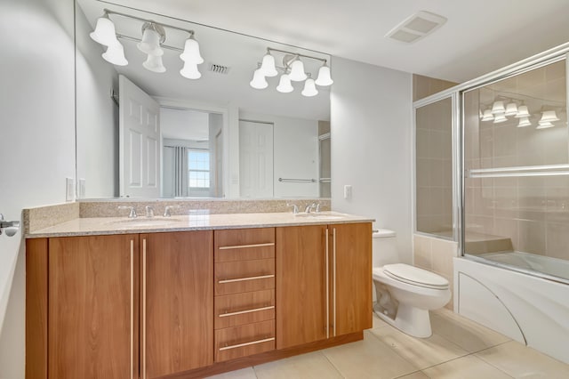 full bathroom with tile patterned flooring, vanity, toilet, and shower / bath combination with glass door