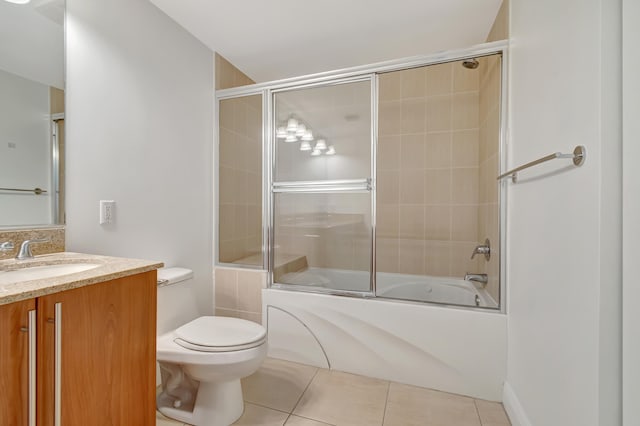 full bathroom featuring tile patterned flooring, vanity, toilet, and shower / bath combination with glass door