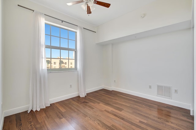 unfurnished room featuring dark hardwood / wood-style flooring and ceiling fan