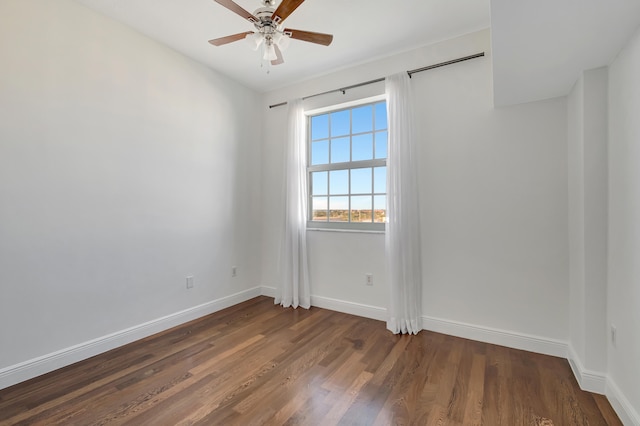 empty room featuring ceiling fan and dark wood-type flooring