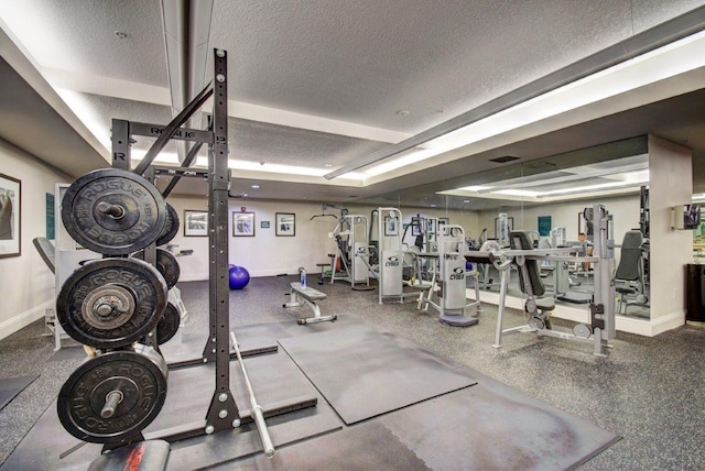 exercise room with a textured ceiling