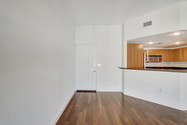 empty room with dark hardwood / wood-style flooring