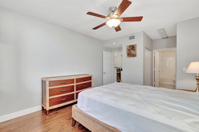 bedroom with connected bathroom, ceiling fan, a closet, and hardwood / wood-style flooring