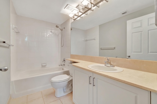 full bathroom with tile patterned flooring, vanity, tiled shower / bath combo, and toilet