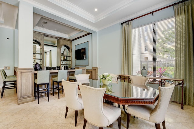 dining room featuring light tile patterned flooring, crown molding, and a tray ceiling