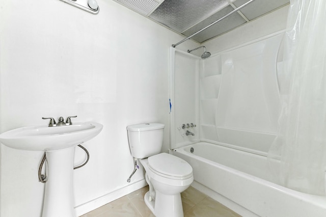 bathroom featuring tile patterned floors, shower / bath combination with curtain, and toilet