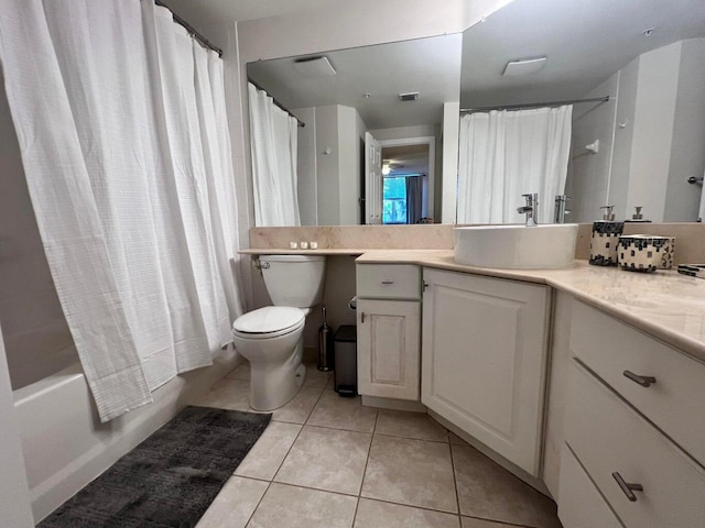 full bathroom with shower / bath combo with shower curtain, tile patterned flooring, vanity, and toilet