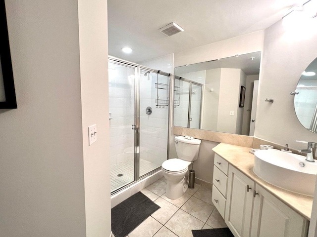 bathroom featuring tile patterned flooring, vanity, toilet, and an enclosed shower