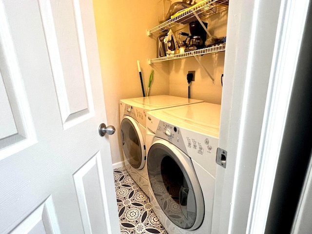 washroom with tile patterned floors and washer and dryer