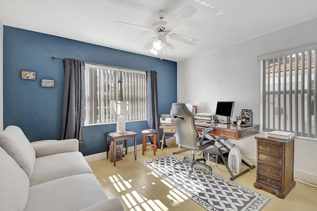 office space with ceiling fan, plenty of natural light, and light wood-type flooring