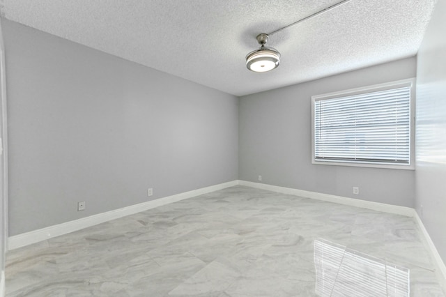 spare room featuring a textured ceiling