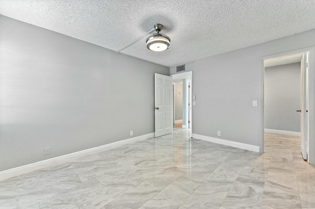 unfurnished bedroom with ceiling fan and a textured ceiling