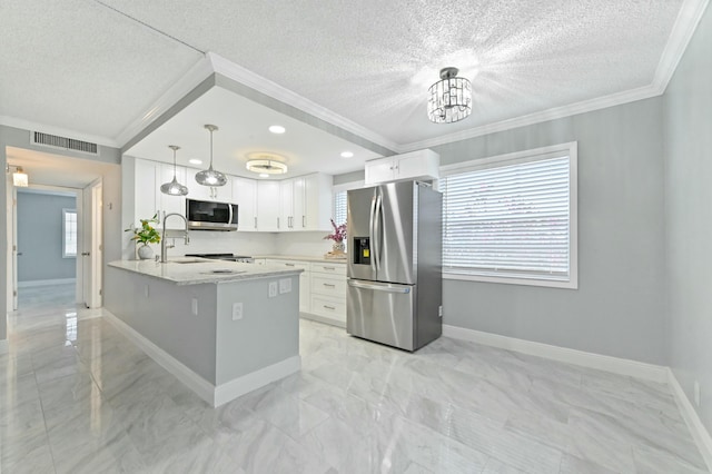 kitchen featuring white cabinets, a textured ceiling, stainless steel appliances, and hanging light fixtures