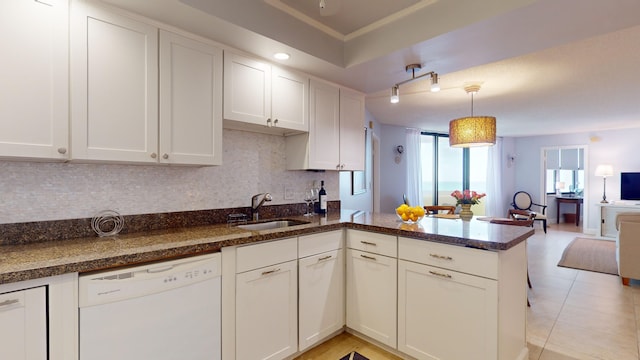 kitchen featuring white cabinetry, dishwasher, sink, kitchen peninsula, and pendant lighting