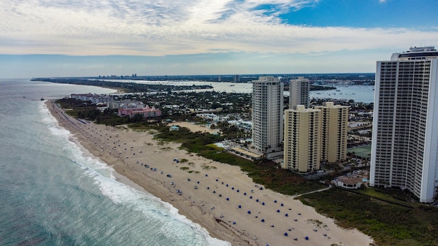 drone / aerial view with a water view and a beach view