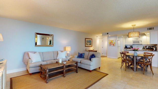 living room with light tile patterned floors and a textured ceiling