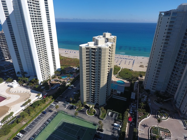 drone / aerial view with a water view and a beach view