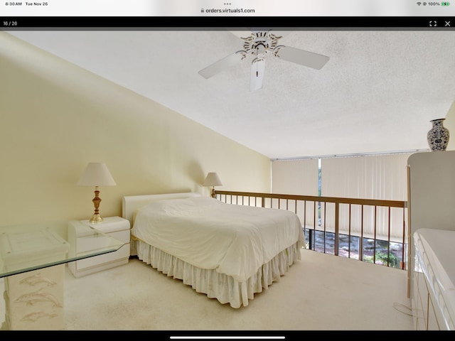 bedroom featuring light carpet, a textured ceiling, and ceiling fan