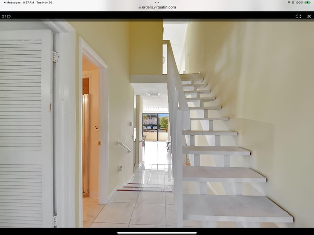 stairs featuring tile patterned flooring