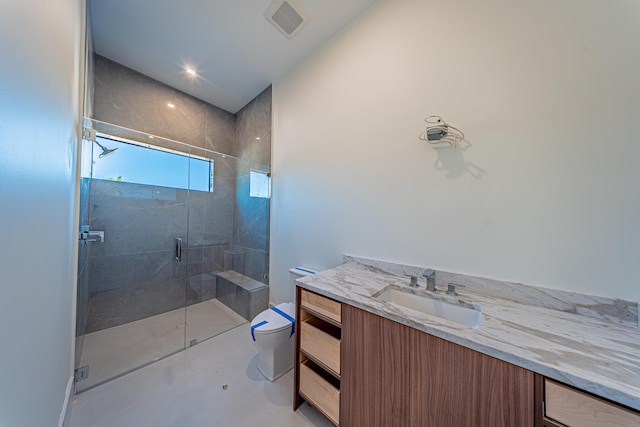 bathroom with vanity, toilet, and walk in shower