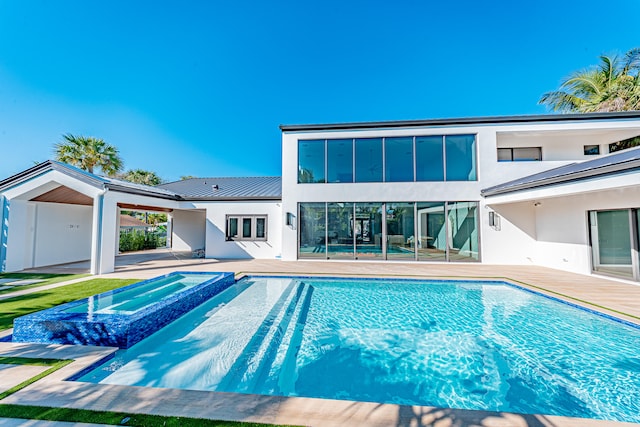 back of house featuring a patio area and a swimming pool with hot tub