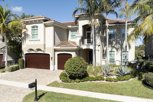 mediterranean / spanish house featuring a balcony and a garage