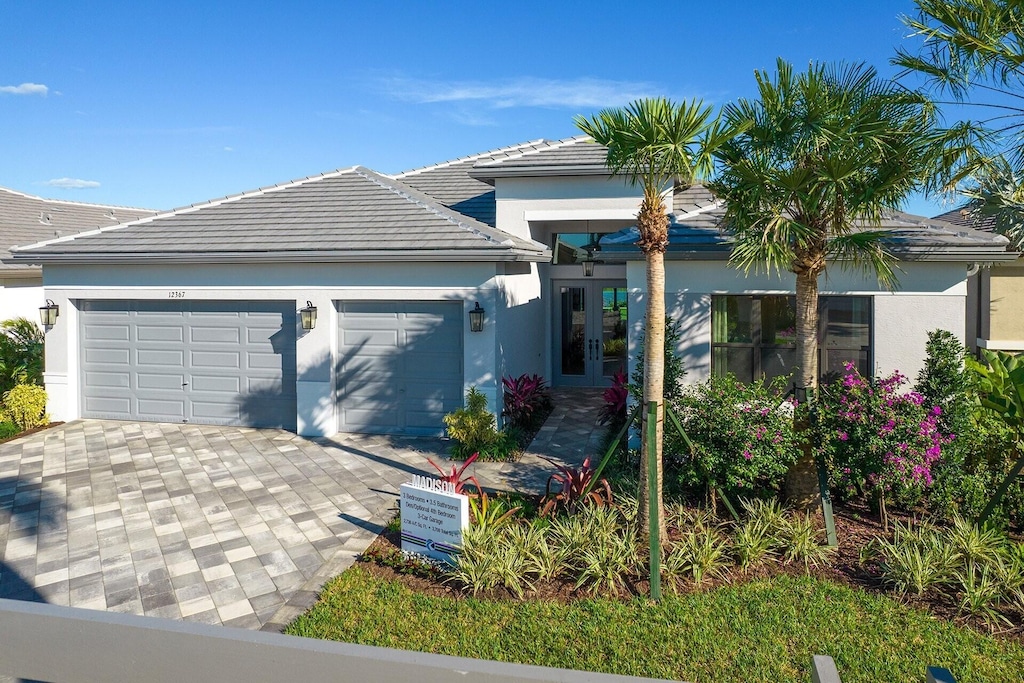 view of front of home with a garage and french doors