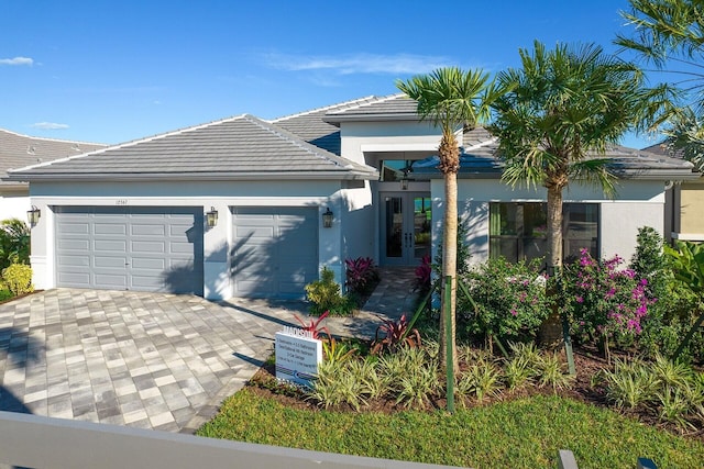 view of front of home with a garage and french doors