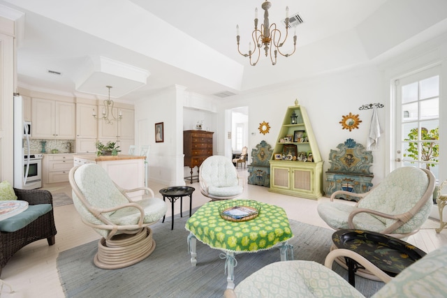 3645 Ocean Dr, Vero Beach, FL 32963 - living area with a chandelier, a tray ceiling, and ornamental molding