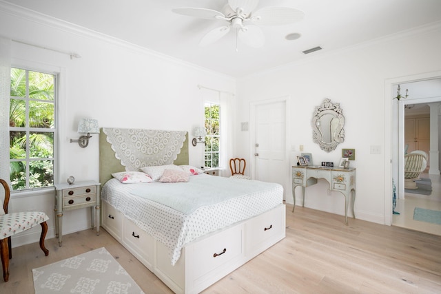 bedroom featuring ceiling fan, crown molding, and light hardwood / wood-style flooring