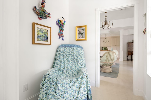 3645 Ocean Dr, Vero Beach, FL 32963 - sitting room featuring a chandelier and baseboards