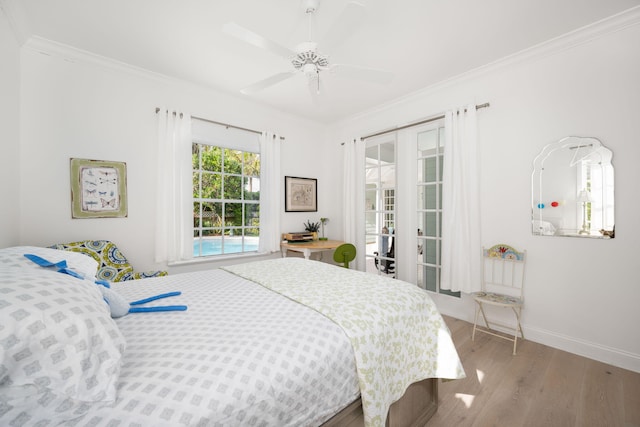 bedroom featuring french doors, light hardwood / wood-style floors, ceiling fan, and ornamental molding