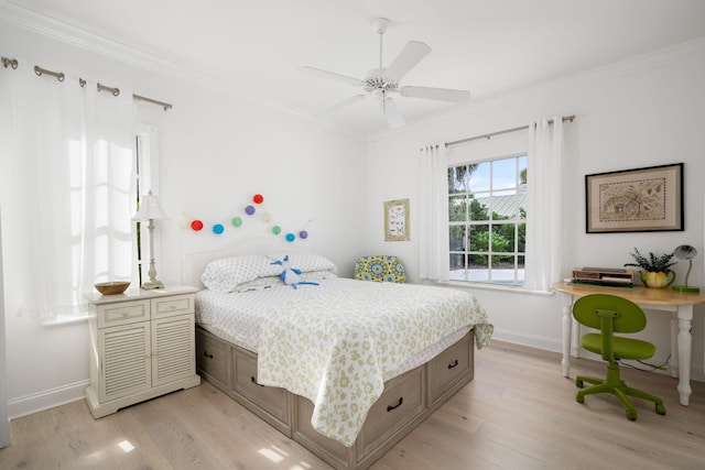 bedroom with light wood-type flooring, ceiling fan, and crown molding