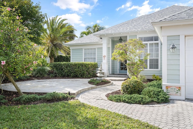 3645 Ocean Dr, Vero Beach, FL 32963 - view of exterior entry featuring a shingled roof