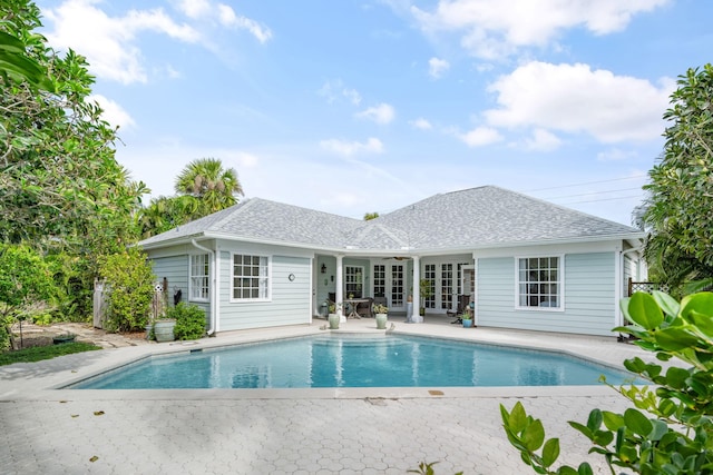 view of swimming pool featuring french doors and a patio