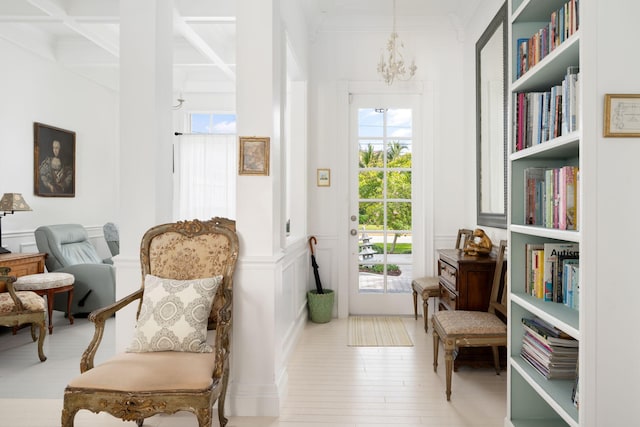 3645 Ocean Dr, Vero Beach, FL 32963 - sitting room with plenty of natural light, beam ceiling, a chandelier, coffered ceiling, and crown molding