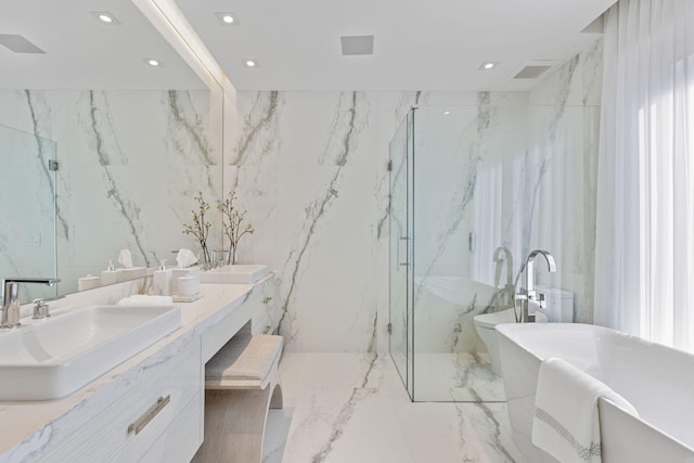 bathroom featuring separate shower and tub and vanity