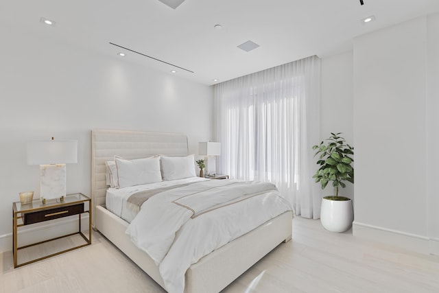 bedroom with light hardwood / wood-style floors