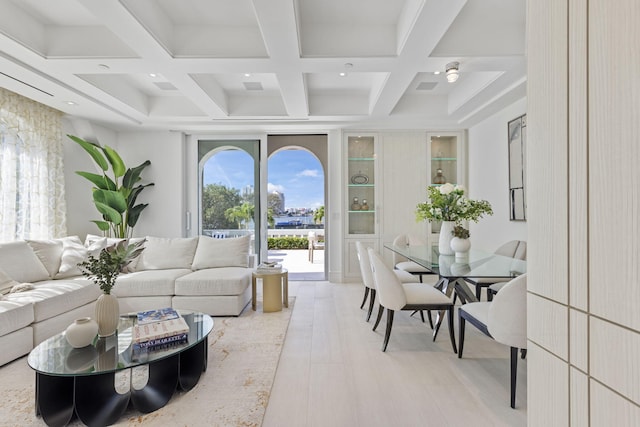 living room with coffered ceiling, light hardwood / wood-style floors, and beamed ceiling