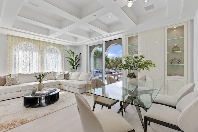 living room featuring beamed ceiling, light hardwood / wood-style floors, and coffered ceiling